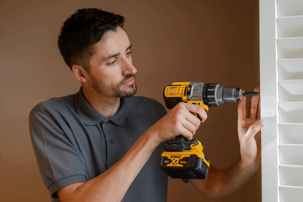 Odd jobs handyman in St Austell fitting blinds with drill